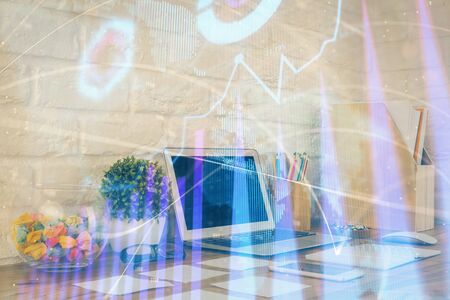 Financial market graph hologram and personal computer on background. Multi exposure. Concept of forex.の写真素材
