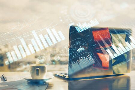 Financial chart drawing and table with computer on background. Double exposure. Concept of international markets.の写真素材
