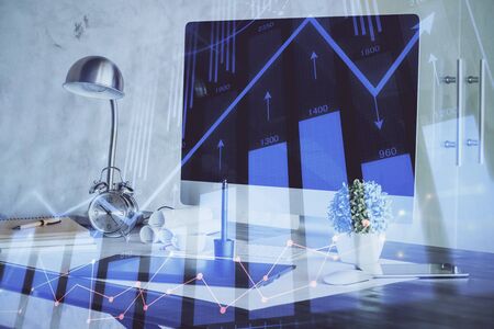 Forex market chart hologram and personal computer background. Double exposure. Concept of investment.の写真素材