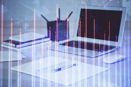 Stock market graph on background with desk and personal computer. Double exposure. Concept of...