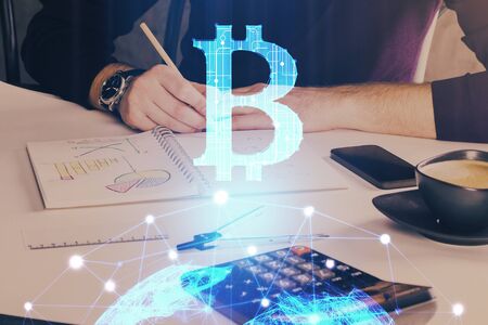 Mans hands working with notes background. Cryptocurrency and finance concept.