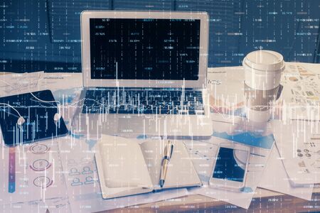 Financial chart drawing and table with computer on background. Multi exposure. Concept of...