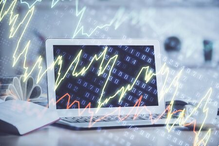 Forex Chart hologram on table with computer background. Double exposure. Concept of financial markets.の写真素材