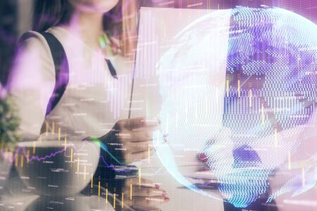 Double exposure of hands making notes with forex chart huds. Stock market concept.の写真素材