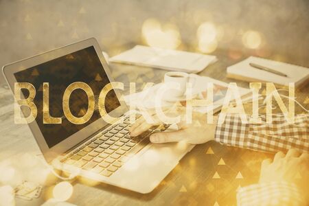 Blockchain theme hologram with man working on computer on background. Concept of crypto chain. Double exposure.の写真素材