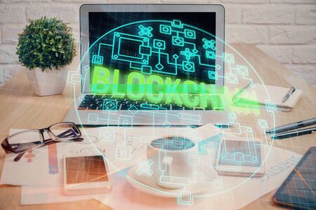 Double exposure of blockchain and crypto economy theme hologram and table with computer background. Concept of bitcoin cryptocurrency.の写真素材