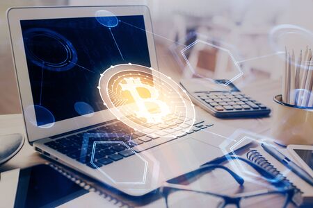 Double exposure of blockchain and crypto economy theme hologram and table with computer background....