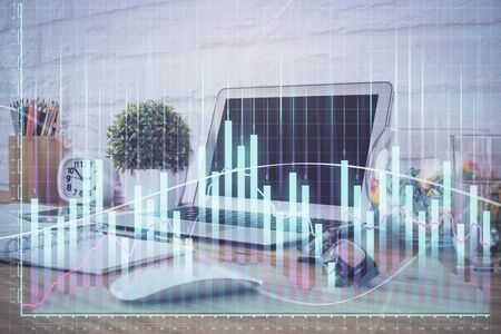 Financial market graph hologram and personal computer on background. Multi exposure. Concept of forex.の写真素材