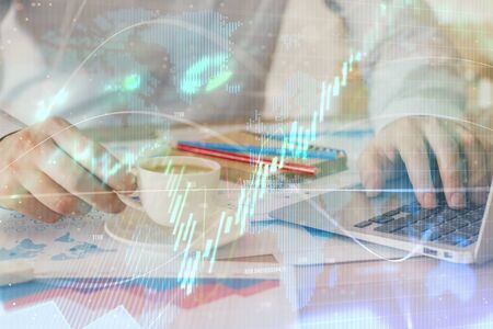 Forex graph with businessman working on computer in office