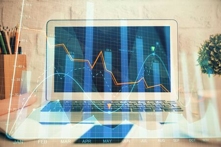 Forex market chart hologram and personal computerの写真素材