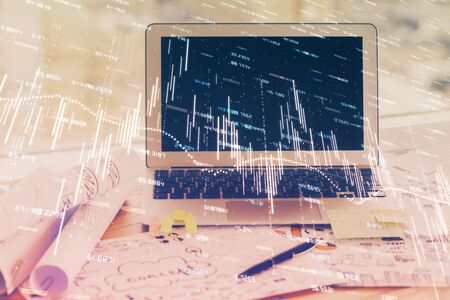 Forex market graph hologram and personal computer on background. Double exposure. Concept of investment.の写真素材