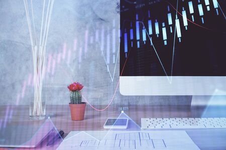 Forex graph hologram on table with computerの写真素材