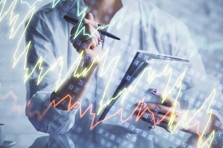 Financial chart drawn over hands taking notes background. Concept of research. Multi exposure