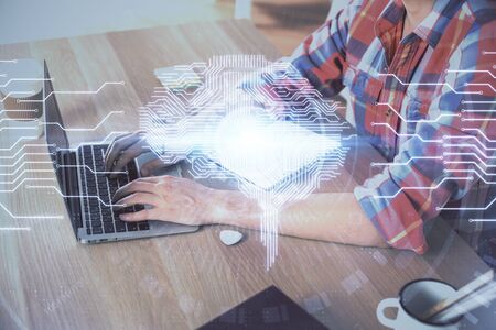 Man typing on keyboard background with brain hologram. Concept of big Data.の写真素材