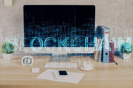 Double exposure of blockchain and crypto economy theme hologram and table with computer background....