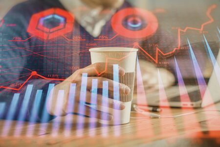 Forex graph with businessman working on computer in office on background. Concept of hardworking....