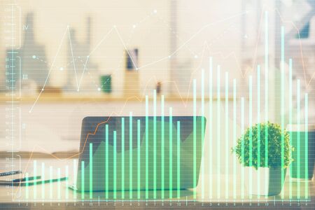 Financial graph colorful drawing and table with computer on background. Multi exposure. Concept of international markets.の写真素材