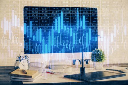 Financial chart drawing and table with computer on background. Multi exposure. Concept of international markets.の写真素材