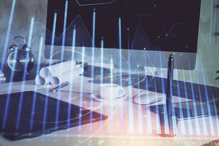 Forex Chart hologram on table with computer background. Multi exposure. Concept of financial markets.の写真素材
