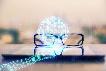 Crypto theme hologram with glasses on the table background. Concept of blockchain. Double exposure.の写真素材