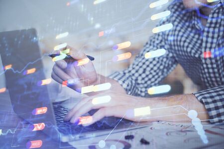 Businessman with computer background with technology theme hologram. Concept of hightech. Multi exposure.の写真素材