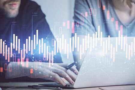 Forex graph with businessman typing on computer in office on background. Concept of analysis. Double...
