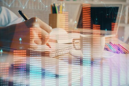 Financial chart drawn over hands taking notes background. Concept of research. Double exposure