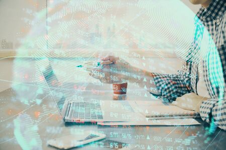 Multi exposure of businessman working on laptop on background. International business hologram in front. Concept of success.の写真素材