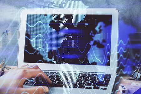 Forex graph with businessman working on laptop on background. Concept of hardworking. Multi exposure.の写真素材