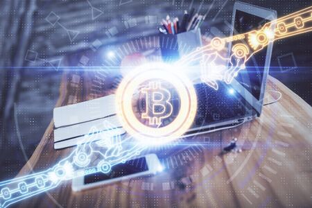 Double exposure of blockchain and crypto economy theme hologram and table with computer background. Concept of bitcoin cryptocurrency.の写真素材