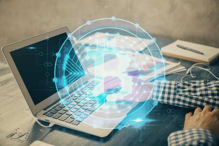 Blockchain theme hologram with man working on computer on background. Concept of crypto chain....