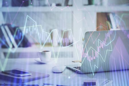 Stock market chart hologram drawn on personal computer background. Double exposure. Concept of investment.の写真素材