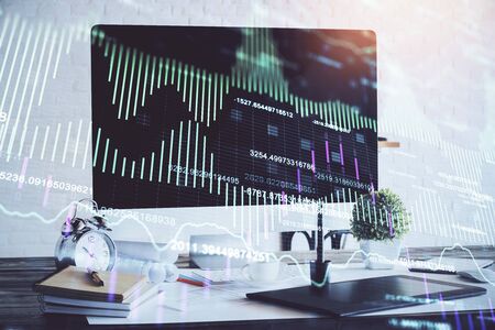 Forex market chart hologram and personal computer background. Double exposure. Concept of investment.の写真素材