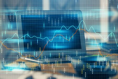 Financial chart drawing and table with computer on background. Double exposure. Concept of international markets.の写真素材
