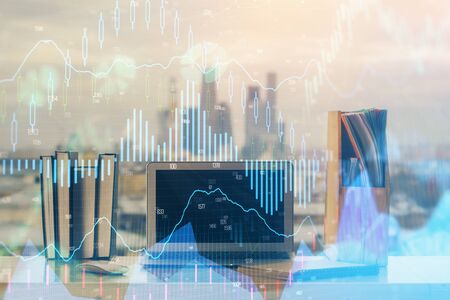 Forex market chart hologram and personal computer background. Multi exposure. Concept of investment.の写真素材