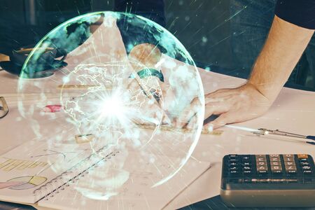 Double exposure of hands and notepad with business icons. Concept of international business.の写真素材