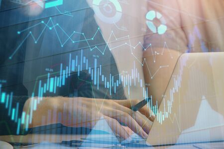 Forex graph with businessman typing on computer in office on background. Concept of analysis. Double...