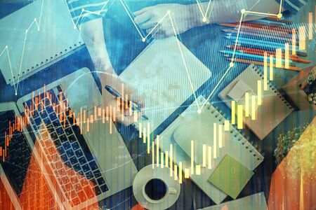 Financial chart drawn over hands taking notes background. Concept of research. Double exposure
