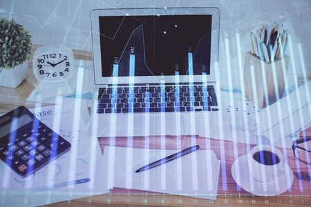 Forex Chart hologram on table with computer background. Double exposure. Concept of financial markets.の写真素材