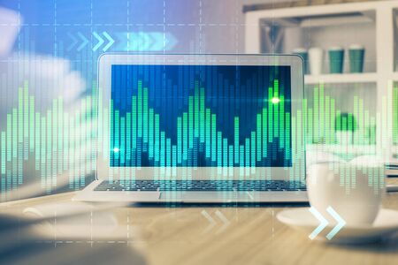 Financial market graph hologram and personal computer on background. Multi exposure. Concept of...