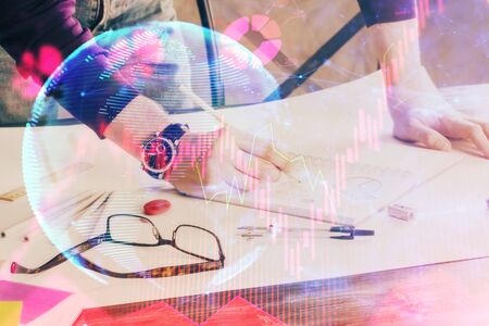 Double exposure of Man writing in notepad with business icons on background.の写真素材