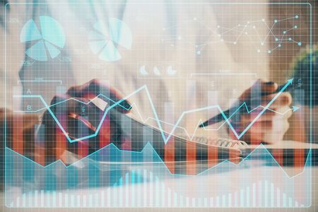 Financial chart drawn over hands taking notes background. Concept of research. Multi exposureの写真素材