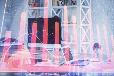Forex market chart hologram and personal computer background. Multi exposure. Concept of investment.の写真素材