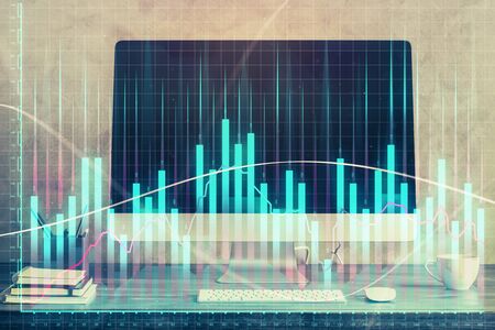 Forex market graph hologram and personal computer on background. Double exposure. Concept of investment.の写真素材