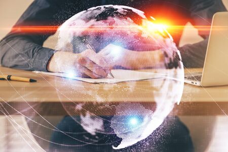 Double exposure of hands and notepad with business icons.の写真素材
