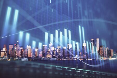 Financial graph on night city scape with tall buildings background double exposure. Analysis concept.の写真素材