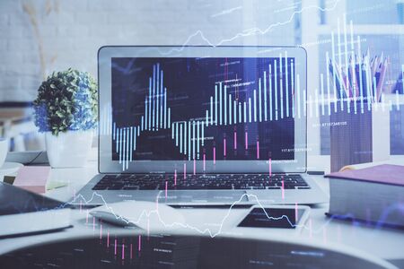 Financial market graph hologram and personal computer on background. Multi exposure. Concept of forex.の写真素材