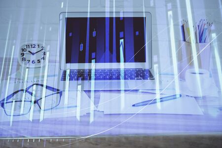 Stock market graph and table with computer background. Double exposure. Concept of financial analysis.の写真素材