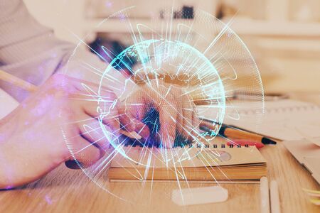 Double exposure of hands and notepad with business icons.の写真素材
