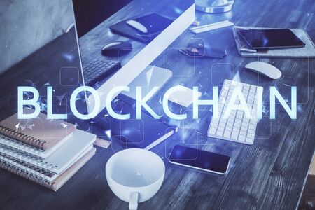 Double exposure of blockchain and crypto economy theme hologram and table with computer background. Concept of bitcoin cryptocurrency.の写真素材